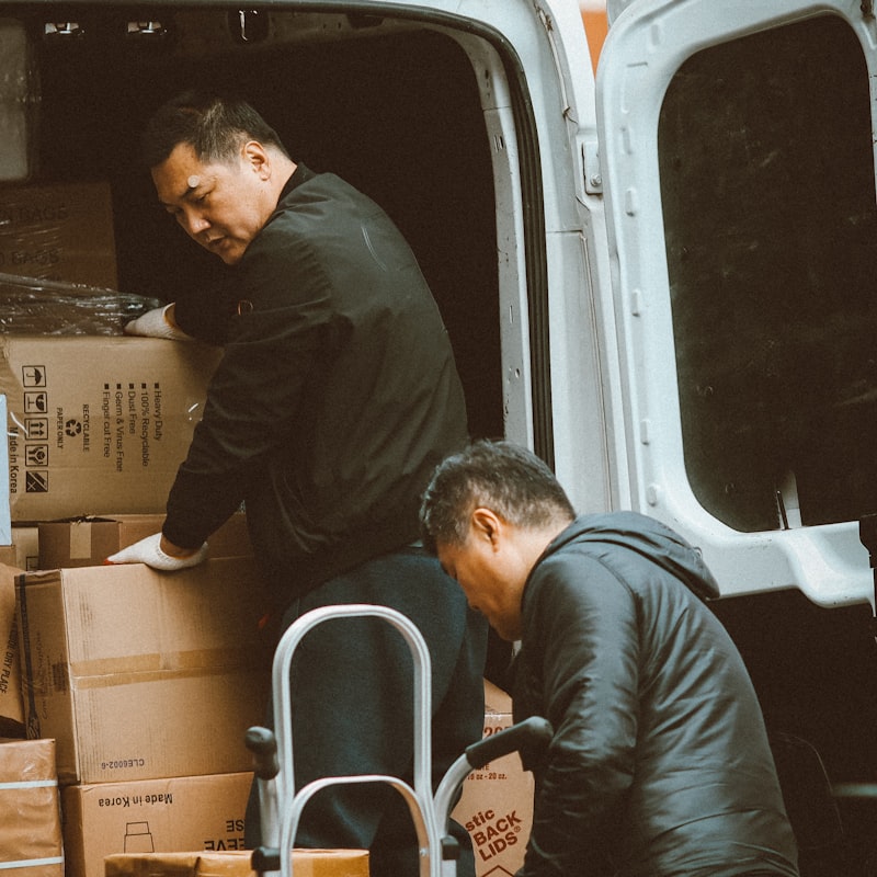 Two-man team loading boxes into the van