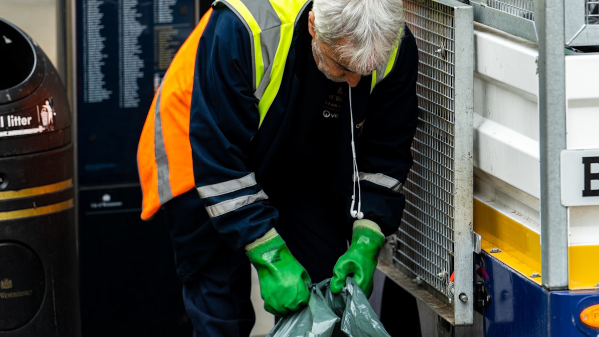 Worker loading rubbish bags